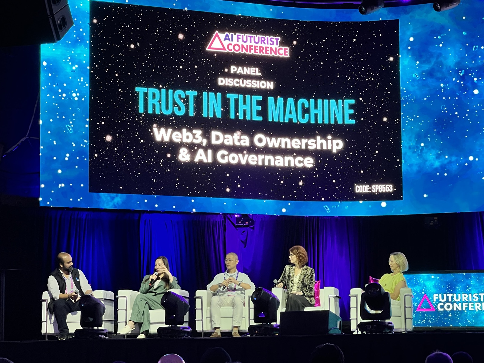 Panelists on stage for the Trust in the Machine: Web3, Data Ownership and AI Governance panel