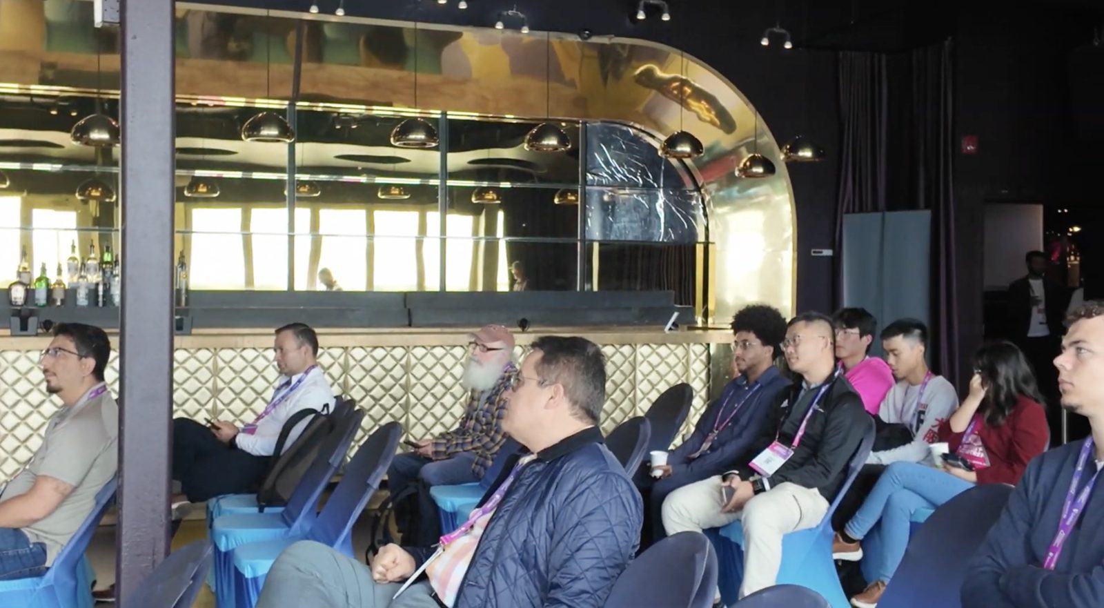 Workshop attendees seated in a lounge area listening to the Agentic Commerce Workshop
